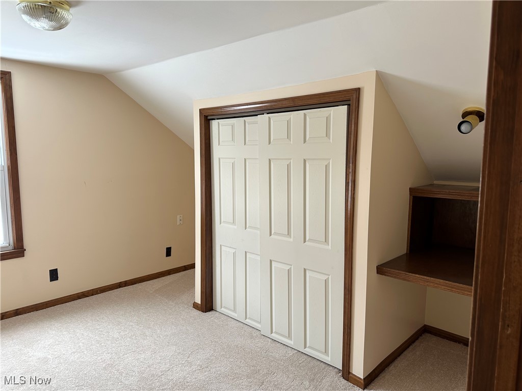 60 Taylor Road Barberton, OH 44203 - Photo 22 of 35 Upstairs bedroom featuring light colored carpet and vaulted ceiling