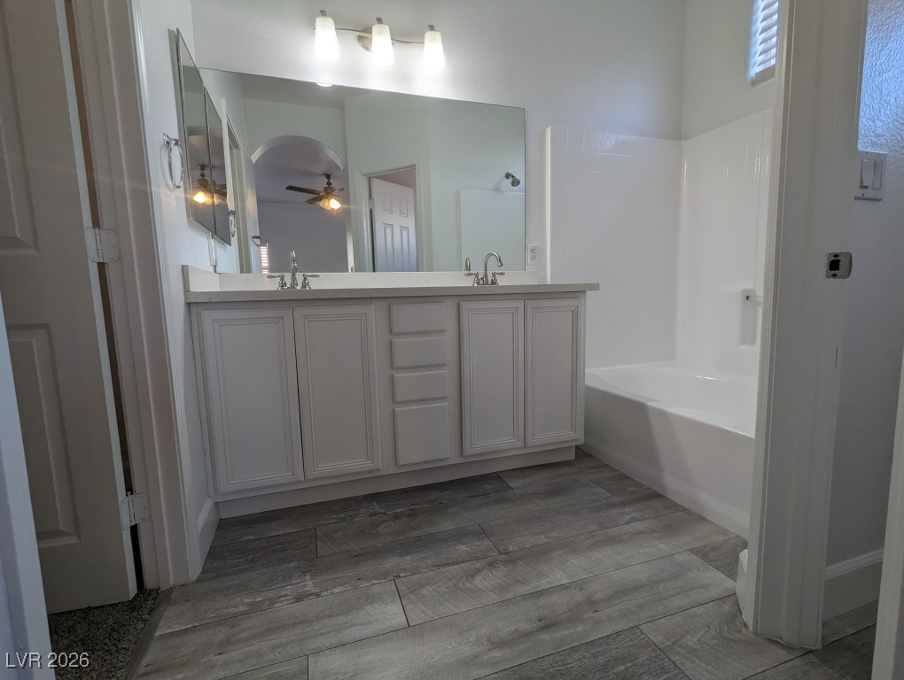 9303 Gilcrease Avenue, Unit 1137 Las Vegas, NV 89149 - Photo 20 of 30 Bathroom featuring ceiling fan, double vanity, light wood-style floors, and shower / tub combination