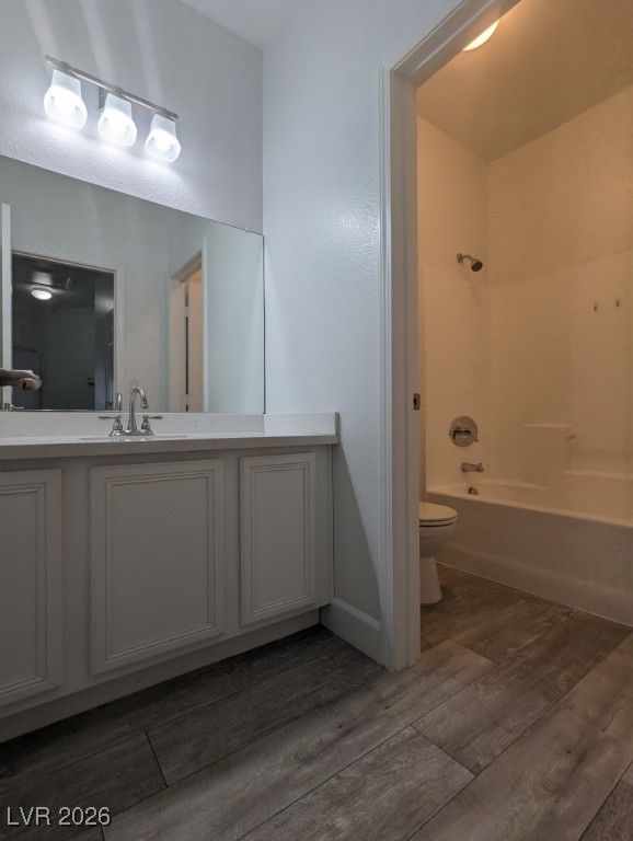 9303 Gilcrease Avenue, Unit 1137 Las Vegas, NV 89149 - Photo 28 of 30 Bathroom featuring vanity, shower / tub combination, and dark wood-style flooring