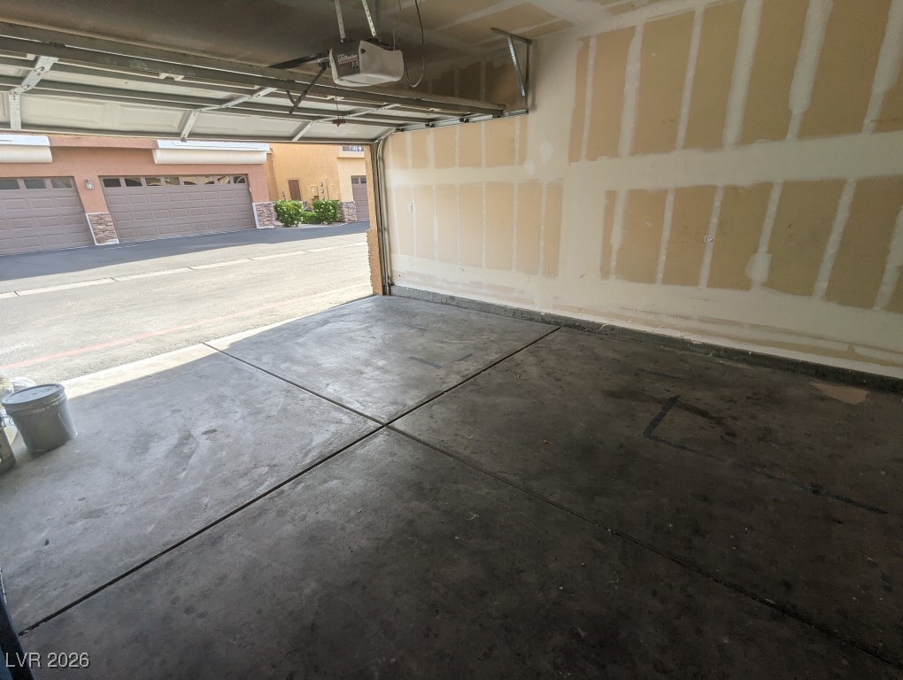 9303 Gilcrease Avenue, Unit 1137 Las Vegas, NV 89149 - Photo 30 of 30 Garage featuring a garage door opener