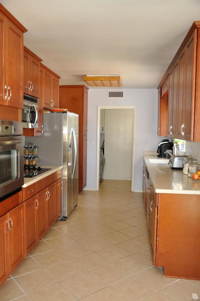 1072 Appleton Road Simi Valley, CA 93065 - Photo 11 of 41 a kitchen with stainless steel appliances granite countertop a refrigerator a stove and a sink with wooden cabinets