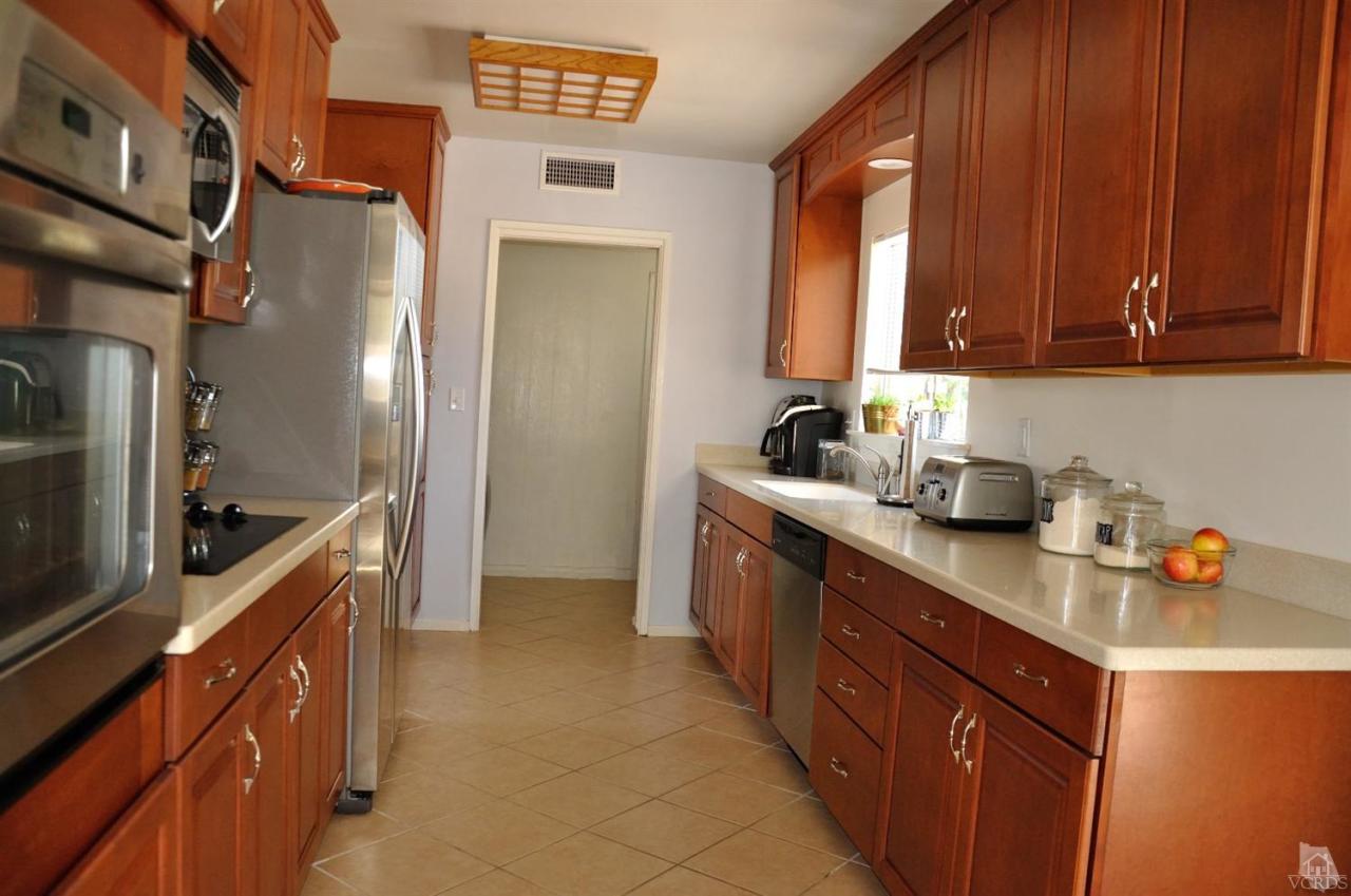 1072 Appleton Road Simi Valley, CA 93065 - Photo 12 of 41 a kitchen with stainless steel appliances granite countertop a sink stove and refrigerator