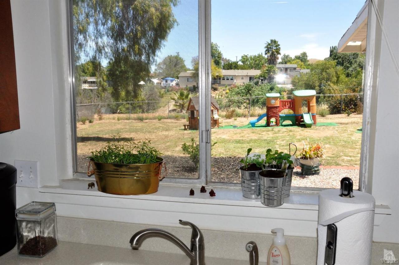 1072 Appleton Road Simi Valley, CA 93065 - Photo 16 of 41 a room with a potted plant on the counter and a view of living room