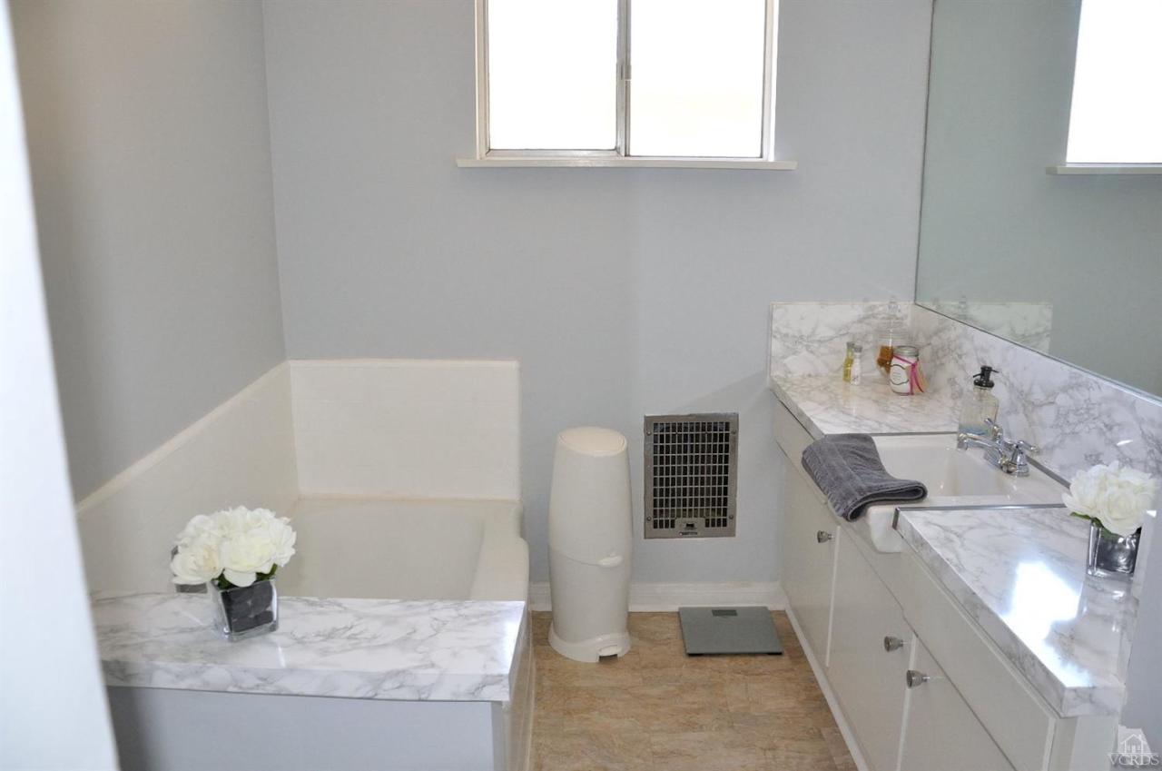 1072 Appleton Road Simi Valley, CA 93065 - Photo 22 of 41 a bathroom with a sink a vanity and a window