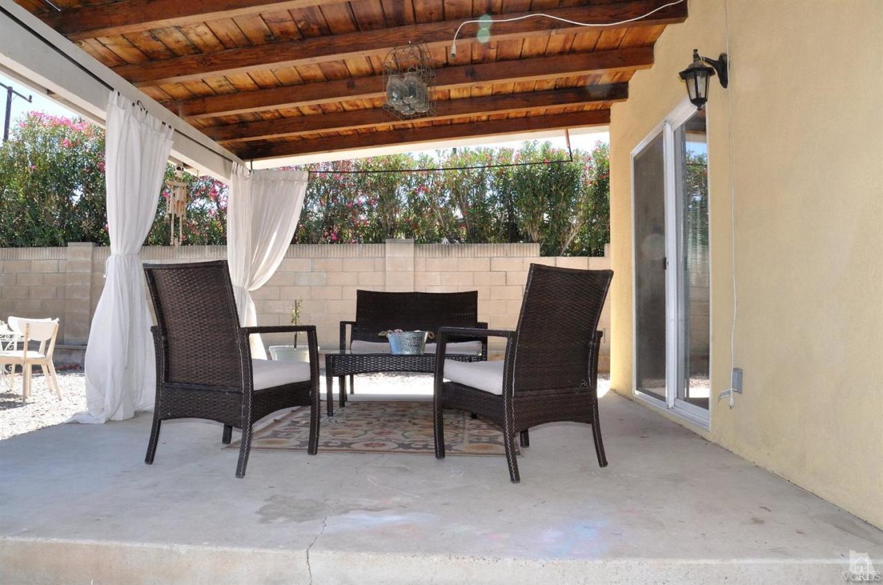 1072 Appleton Road Simi Valley, CA 93065 - Photo 31 of 41 a view of a patio with table and chairs and floor to ceiling window