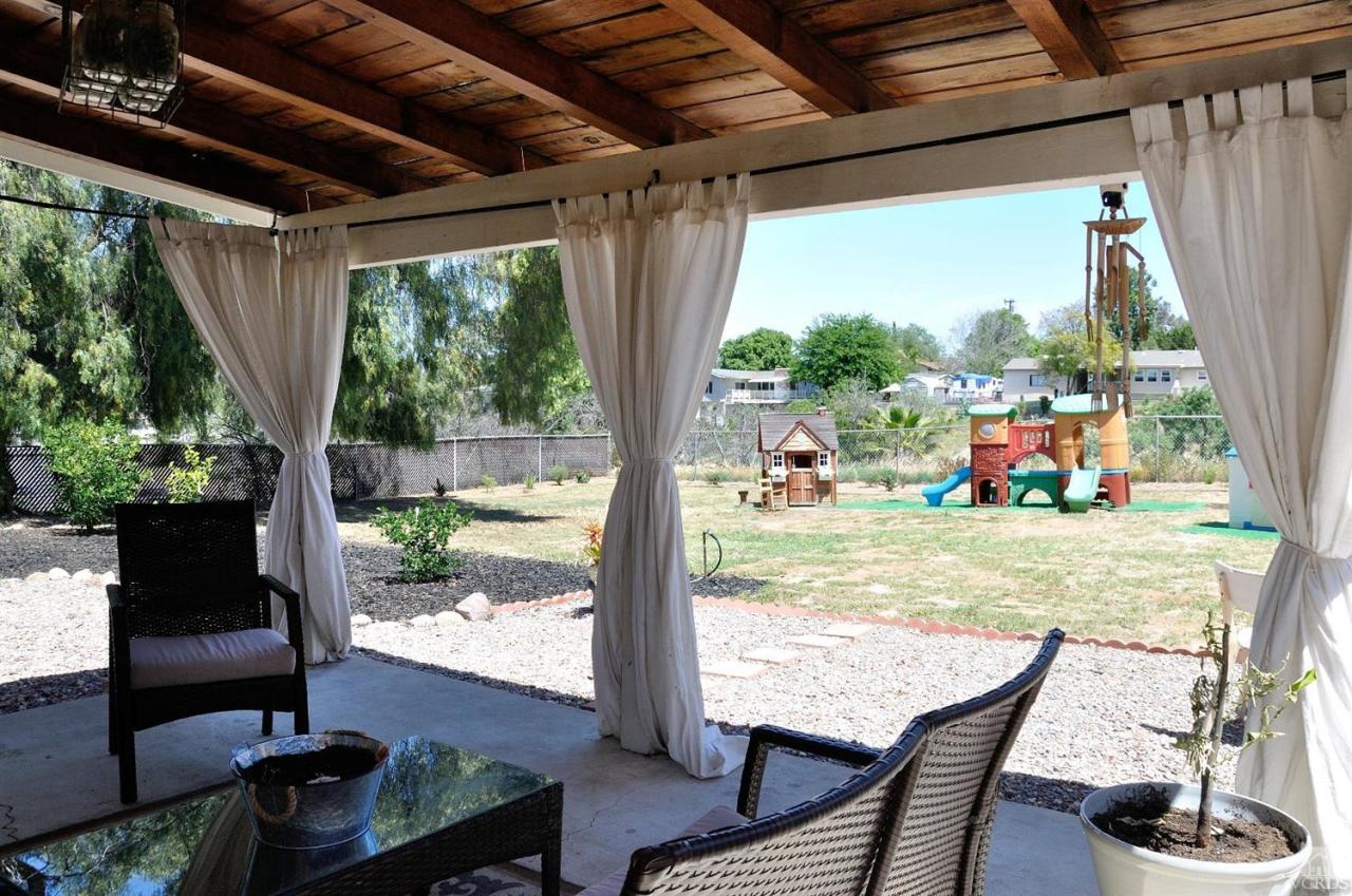 1072 Appleton Road Simi Valley, CA 93065 - Photo 34 of 41 a view of a patio with table and chairs potted plants with wooden floor and floor to ceiling window