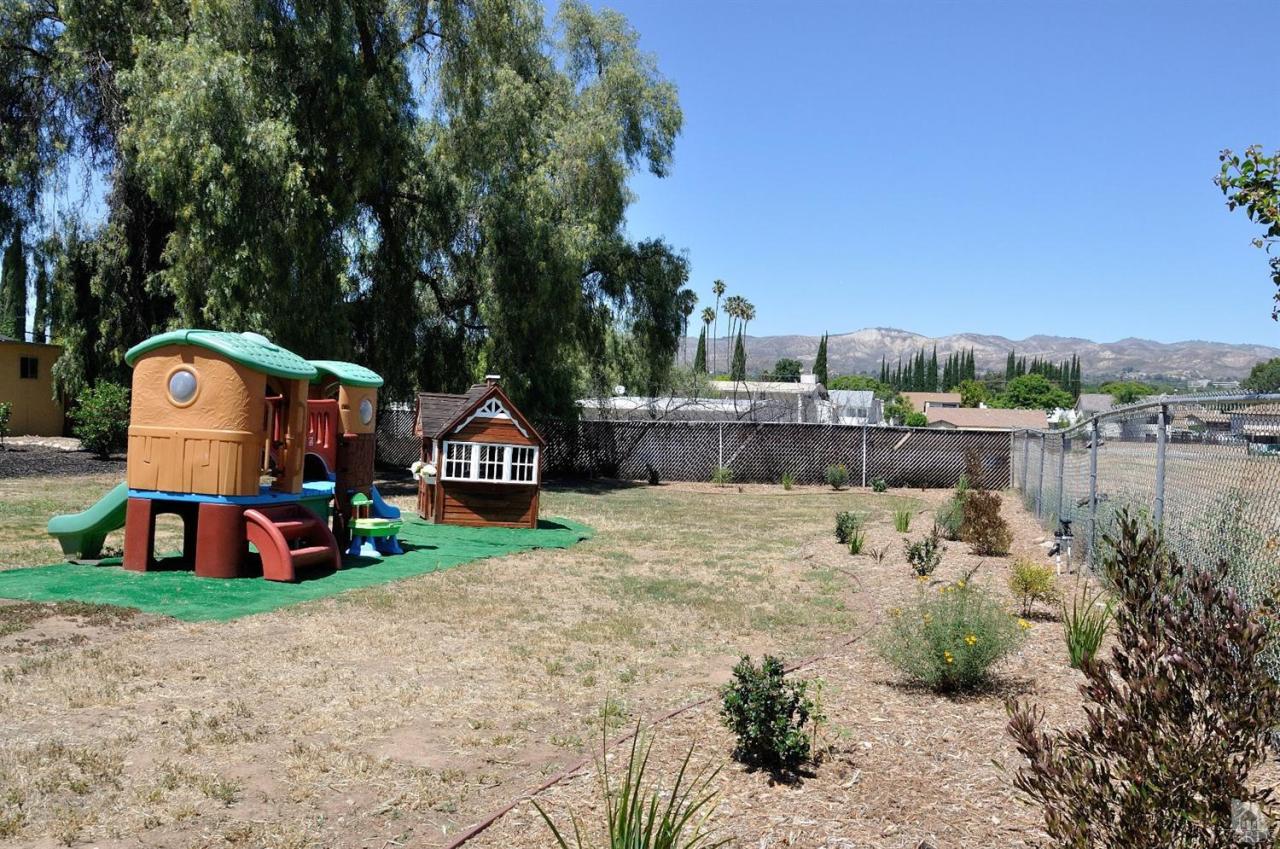 1072 Appleton Road Simi Valley, CA 93065 - Photo 38 of 41 a backyard of a house with table and chairs plants and large trees