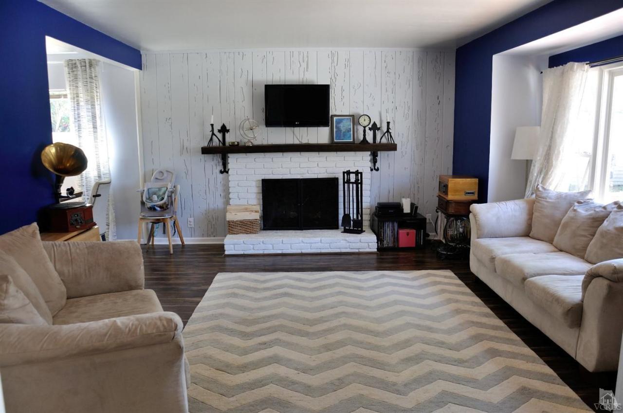 1072 Appleton Road Simi Valley, CA 93065 - Photo 6 of 41 a living room with furniture a flat screen tv and a fireplace
