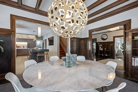 a living room with furniture a large window and a table