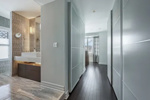 a bedroom with a bed next to a window