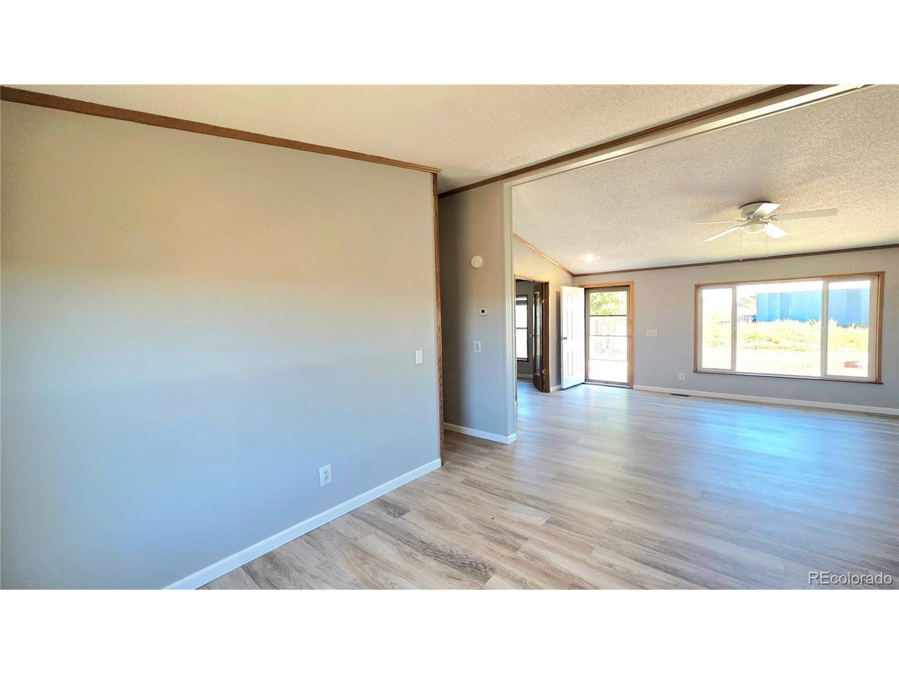10754 County Road East Olney Springs, CO 81062 - Photo 19 of 49 a open space with a window and wooden floor