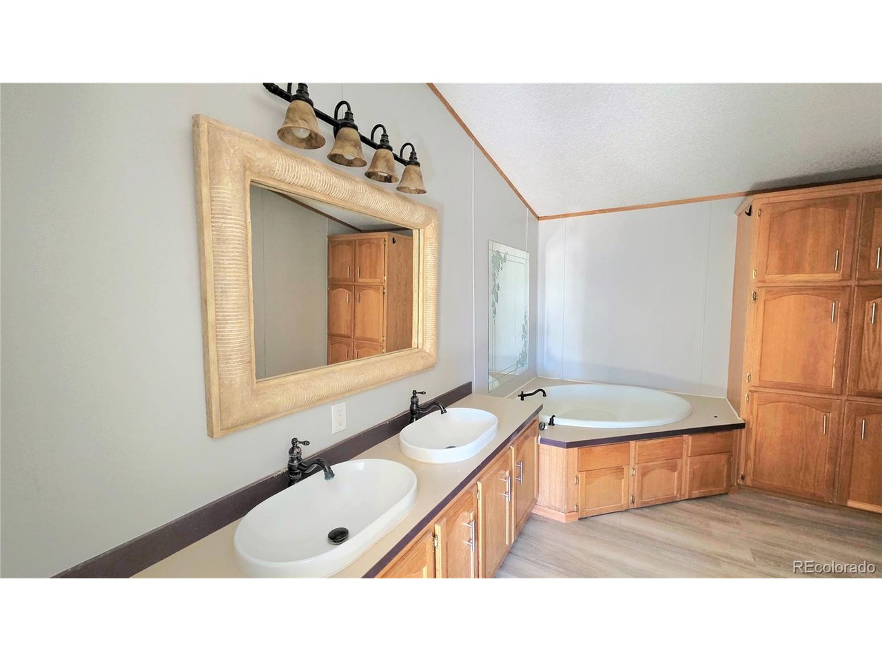 10754 County Road East Olney Springs, CO 81062 - Photo 22 of 49 a bathroom with a sink mirror and a bathtub