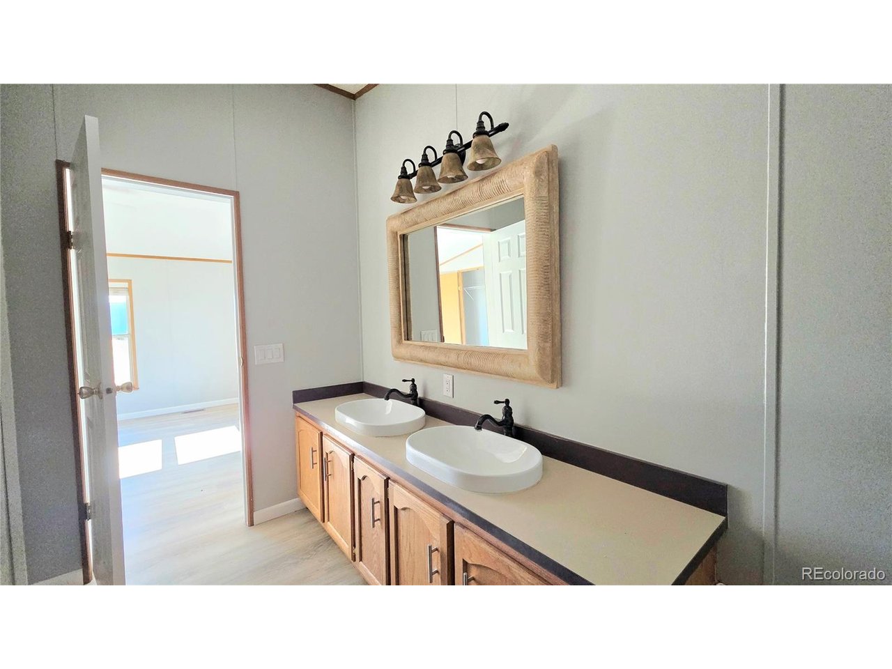 10754 County Road East Olney Springs, CO 81062 - Photo 24 of 49 a bathroom with a sink a window and a mirror