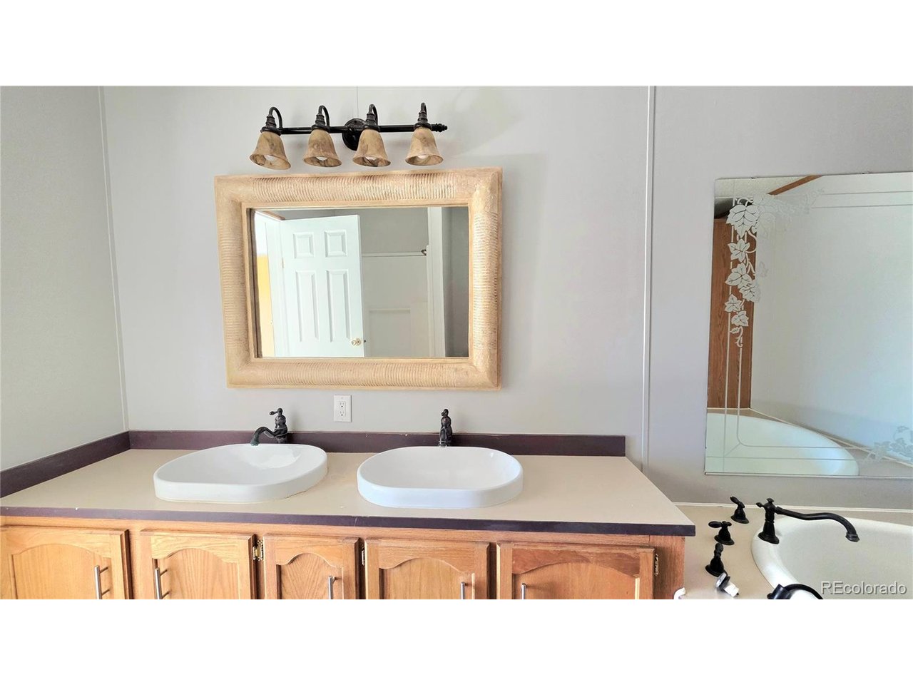 10754 County Road East Olney Springs, CO 81062 - Photo 25 of 49 a bathroom with a sink and a mirror