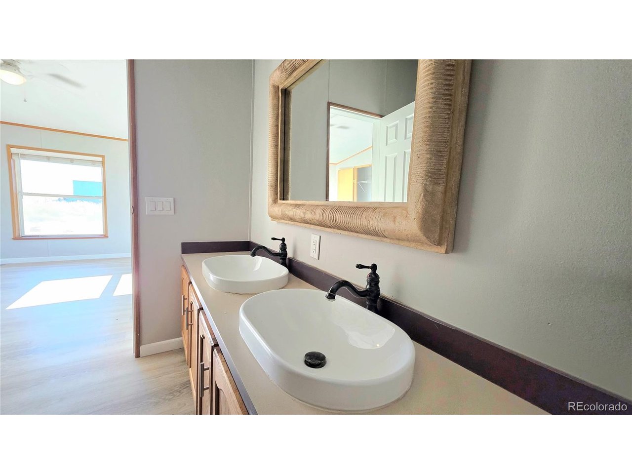 10754 County Road East Olney Springs, CO 81062 - Photo 26 of 49 a bathroom with a sink and a mirror