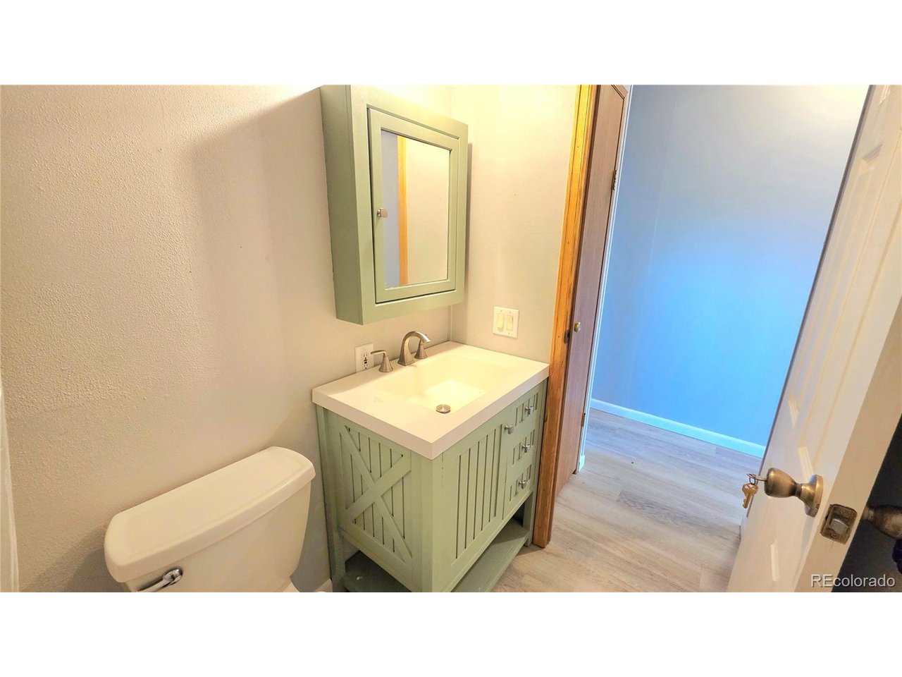 10754 County Road East Olney Springs, CO 81062 - Photo 32 of 49 a bathroom with a sink toilet and mirror