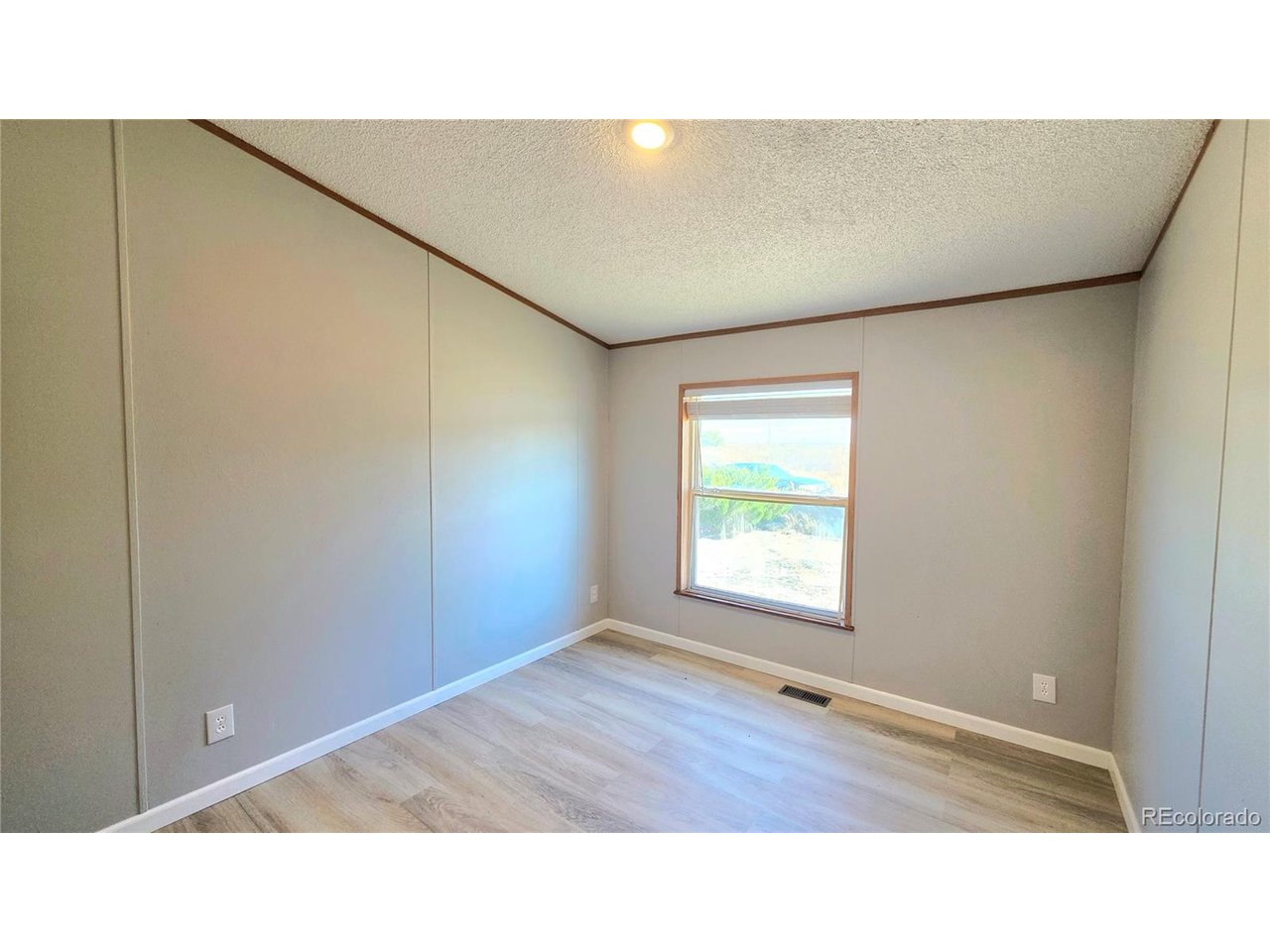 10754 County Road East Olney Springs, CO 81062 - Photo 36 of 49 a open space with a ceiling fan and window