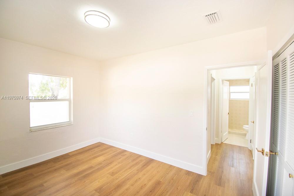 3200 Southwest 2nd Street Miami, FL 33135 - Photo 9 of 10 an empty room with wooden floor and windows