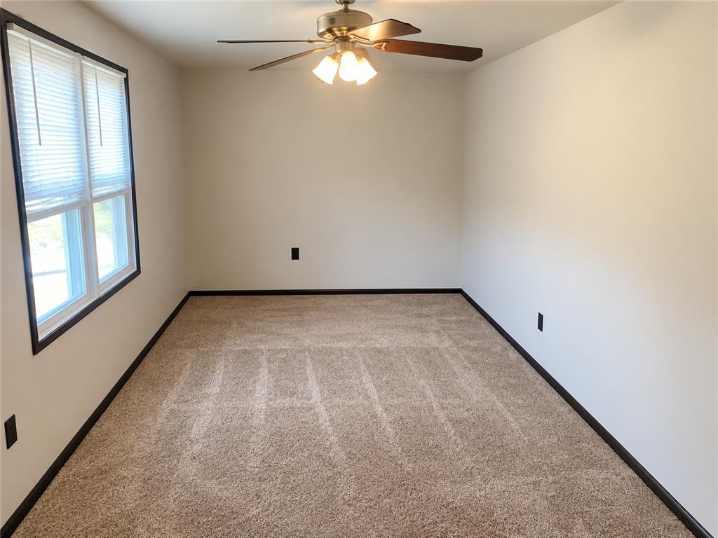 2836 Nazareth Road Easton, PA 18045 - Photo 15 of 19 A well-lit bedroom features plush carpeting and a ceiling fan, offering a comfortable personal retreat.