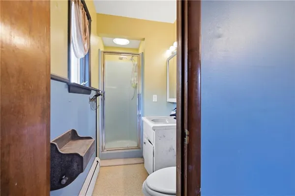 a bathroom with a sink a toilet and shower