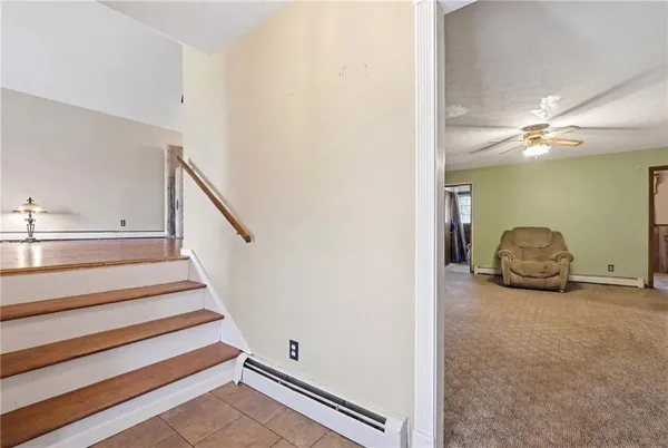 a view of a livingroom with furniture and staircase