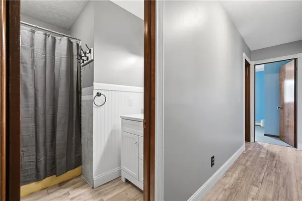 a kitchen with stainless steel appliances granite countertop a refrigerator a sink dishwasher a stove top oven a refrigerator with white cabinets and wooden floor