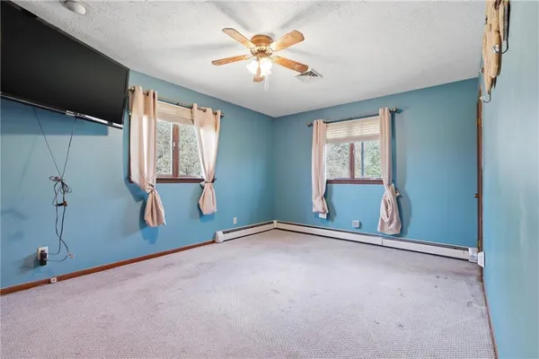 a white toilet sitting next to a shower curtain