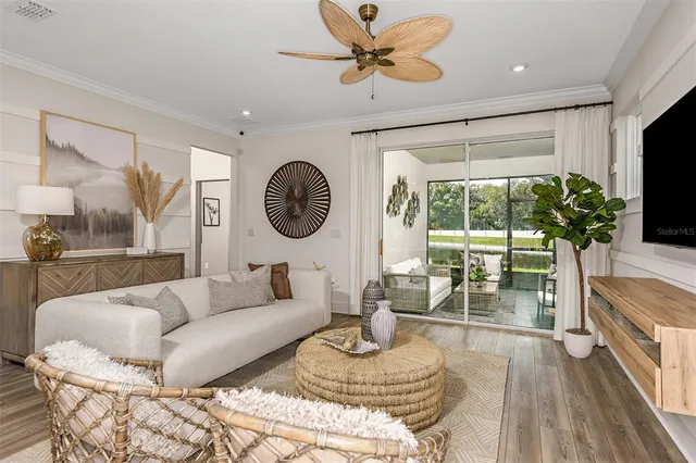 a living room with furniture a wooden floor and chandelier