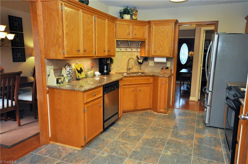 549 Adams Gate Road Winston-Salem, NC 27107 - Photo 7 of 30 Notice the granite countertops and tile backsplash.