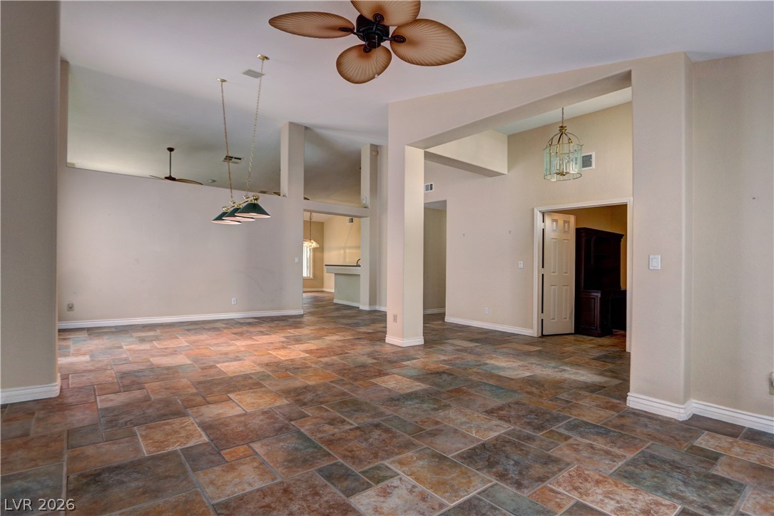 2108 Crestpoint Way Las Vegas, NV 89134 - Photo 4 of 27 A spacious room features a beautiful tiled floor, with high ceilings and integrated lighting.