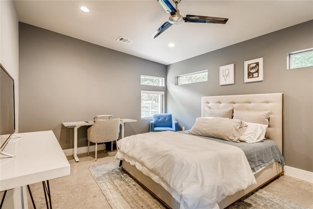 1142 Eleanor Street, Unit 2 Austin, TX 78721 - Photo 14 of 24 Concrete flooring and high ceilings amplify the modern aesthetic of this sleeping chamber.