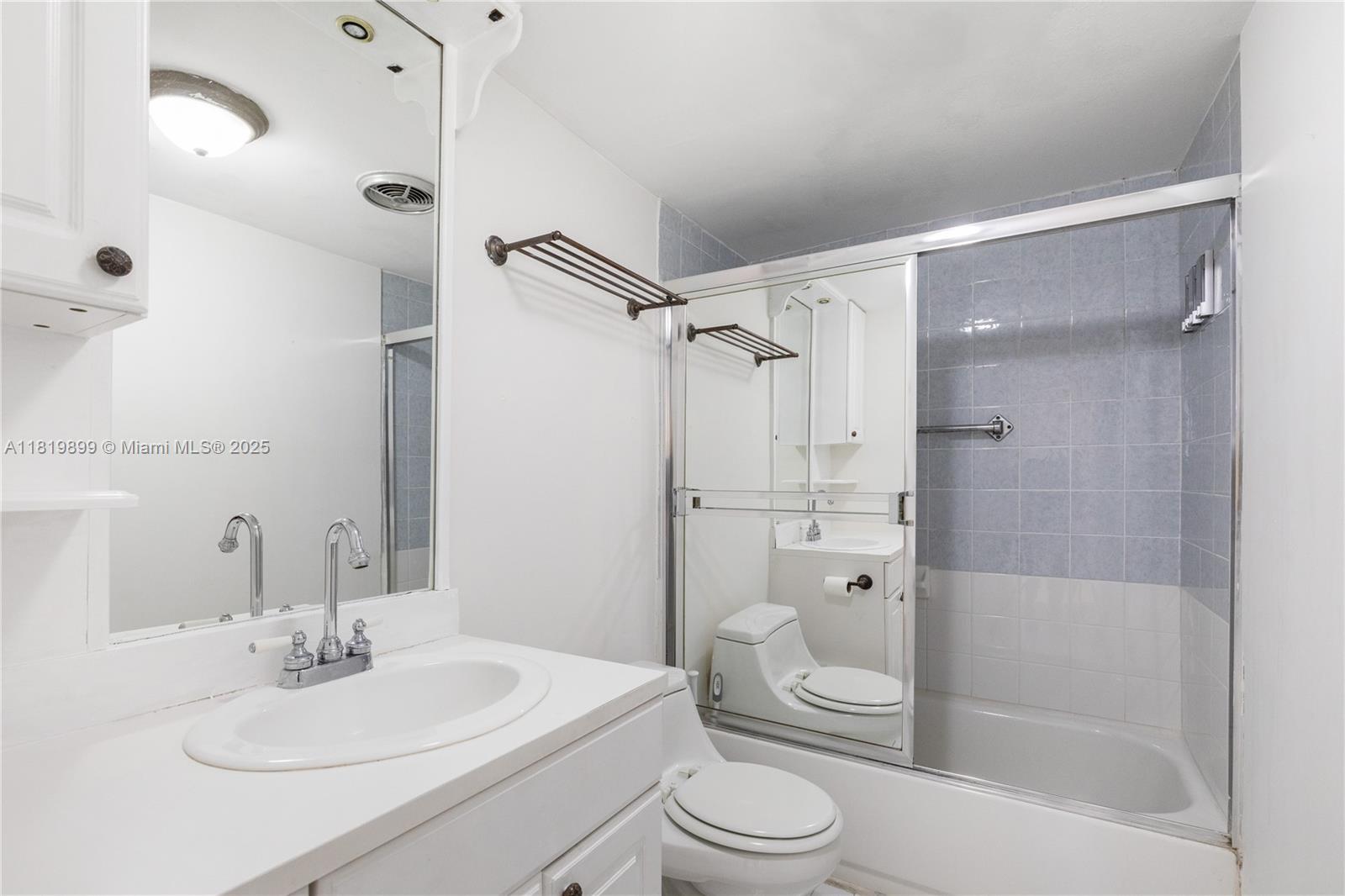 401 Golden Isles Drive, Unit 613 Hallandale Beach, FL 33009 - Photo 17 of 39 a bathroom with a sink a toilet and shower