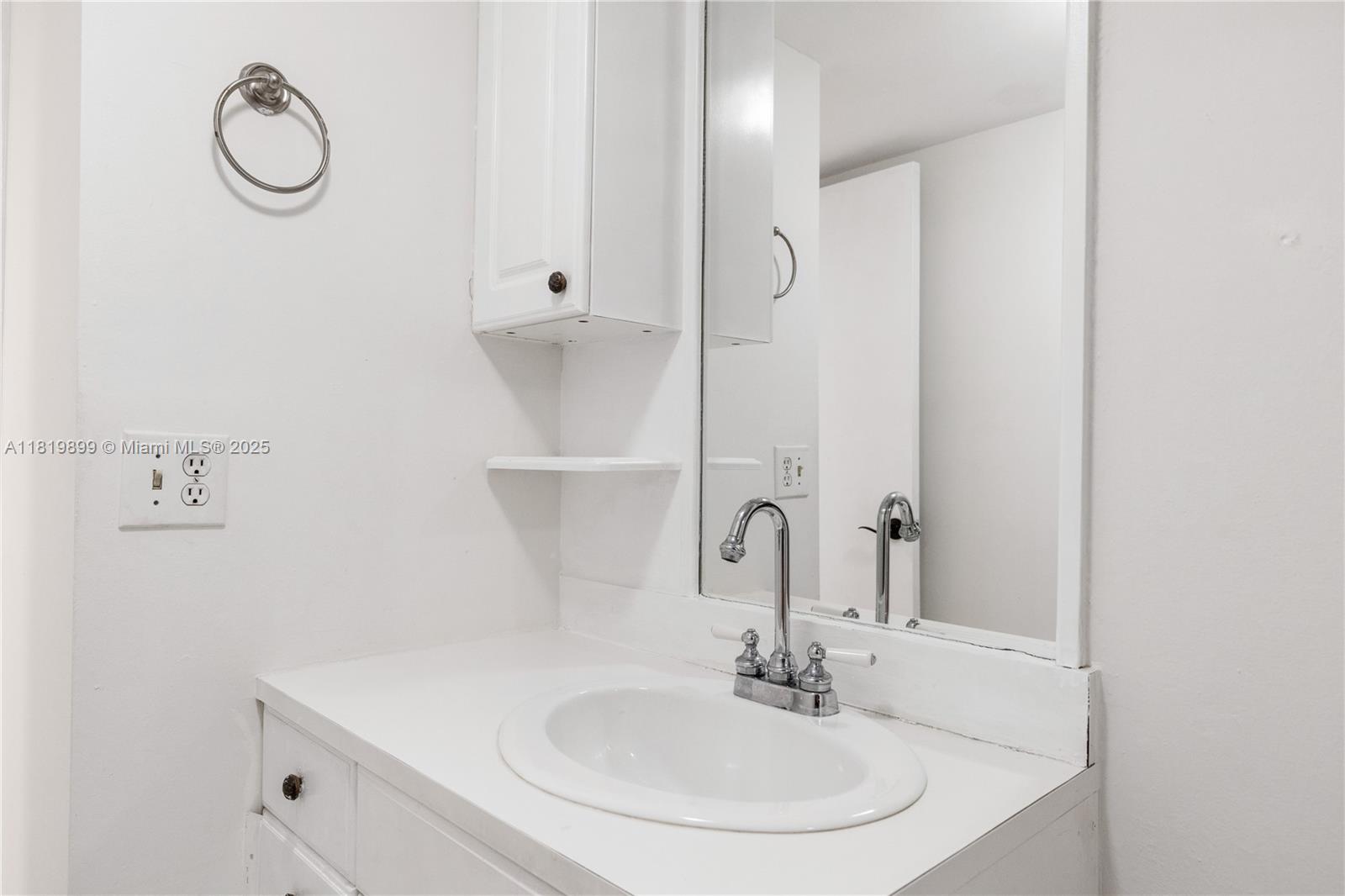 401 Golden Isles Drive, Unit 613 Hallandale Beach, FL 33009 - Photo 19 of 39 a bathroom with a sink and a mirror