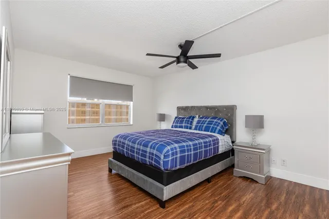 a bedroom with a bed and a large mirror