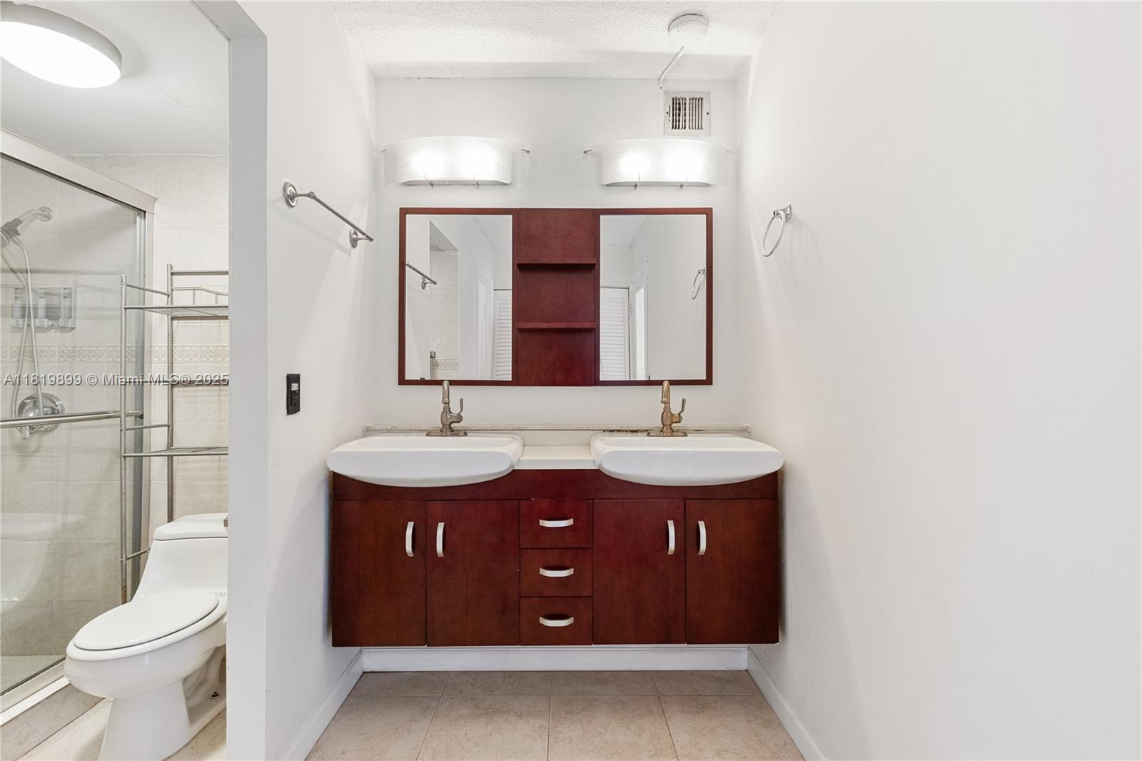 401 Golden Isles Drive, Unit 613 Hallandale Beach, FL 33009 - Photo 25 of 39 a bathroom with a sink and a mirror