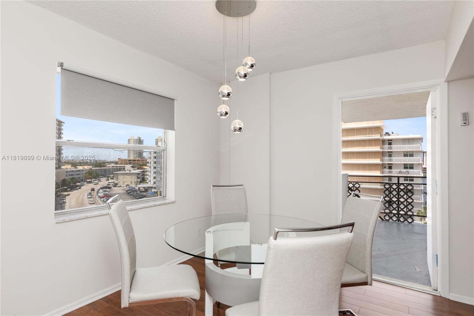 401 Golden Isles Drive, Unit 613 Hallandale Beach, FL 33009 - Photo 28 of 39 a view of a dining room with furniture window and wooden floor