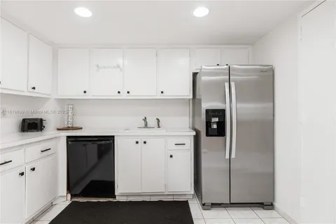 a kitchen with cabinets and stainless steel appliances