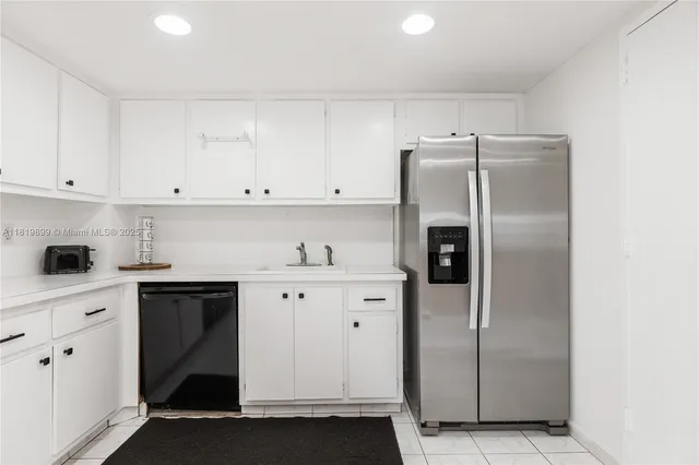 a kitchen with cabinets and stainless steel appliances