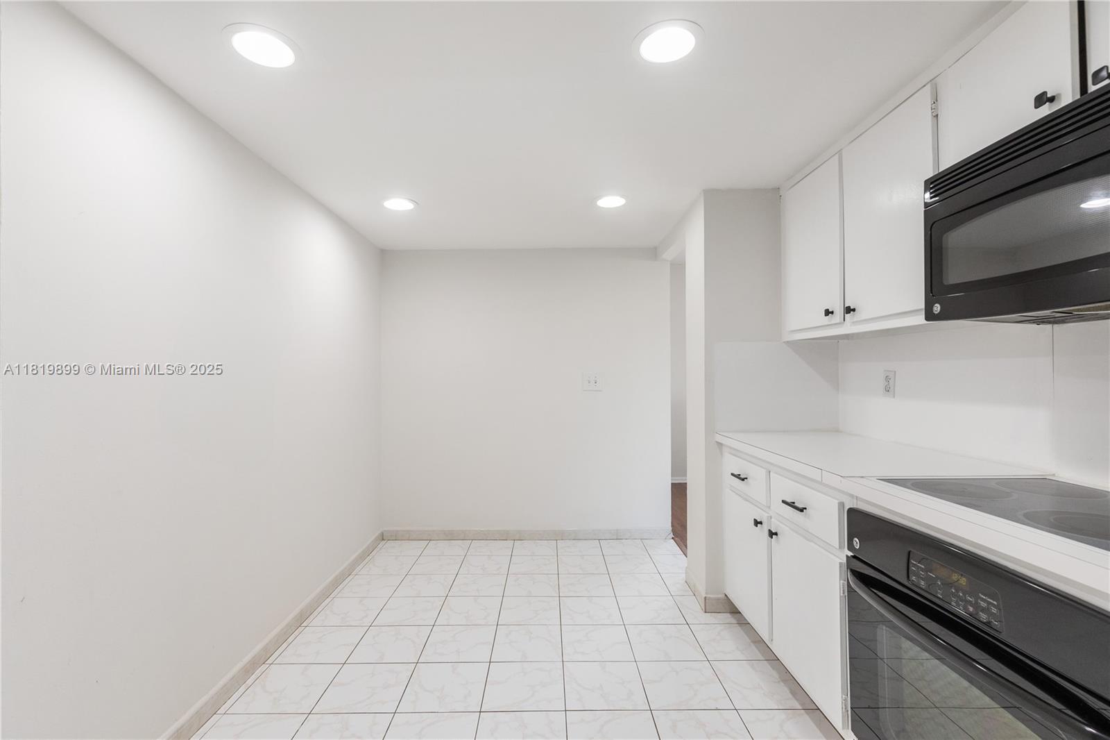 401 Golden Isles Drive, Unit 613 Hallandale Beach, FL 33009 - Photo 33 of 39 a view of a kitchen with electric appliances