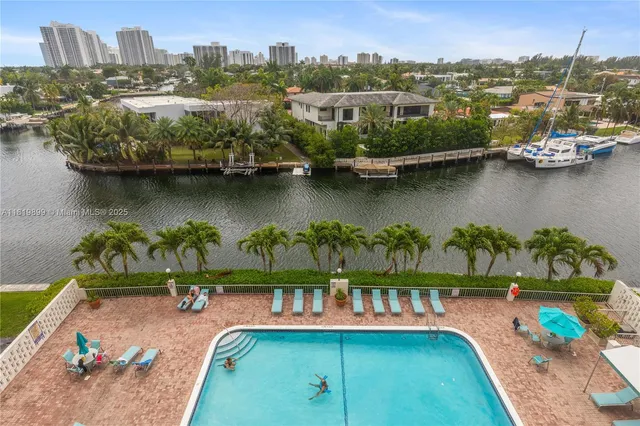 an aerial view of residential houses with outdoor space and lake view
