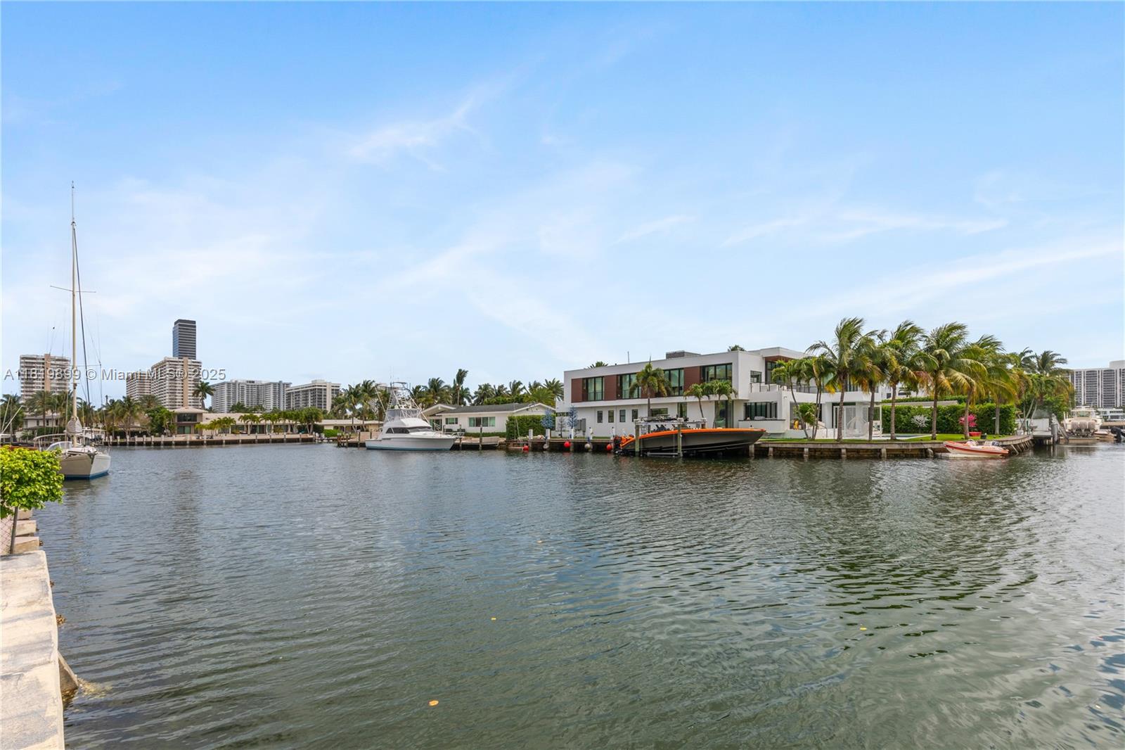 401 Golden Isles Drive, Unit 613 Hallandale Beach, FL 33009 - Photo 37 of 39 a view of a lake with boats and trees in the background
