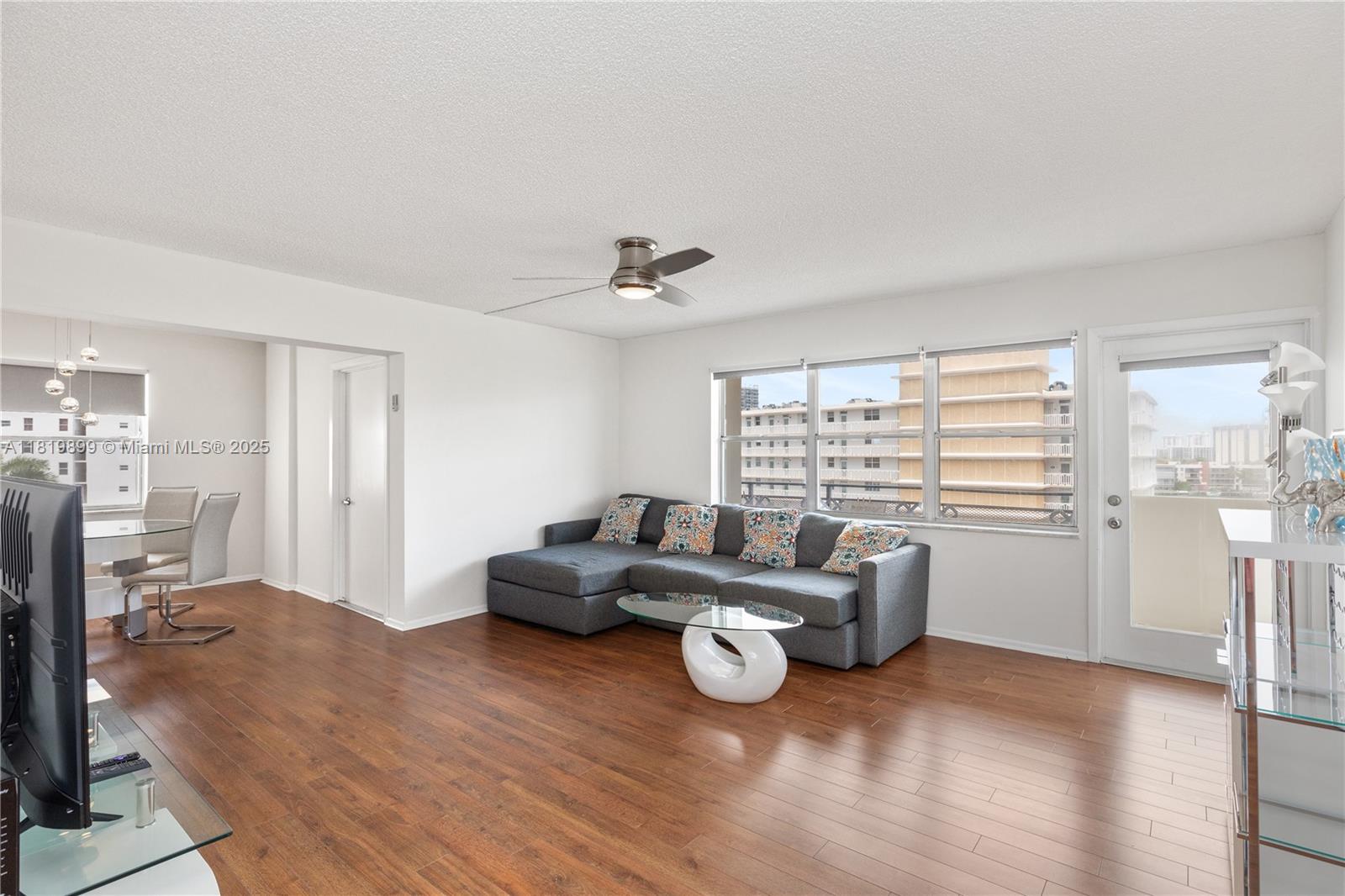 401 Golden Isles Drive, Unit 613 Hallandale Beach, FL 33009 - Photo 4 of 39 a living room with furniture and a large window