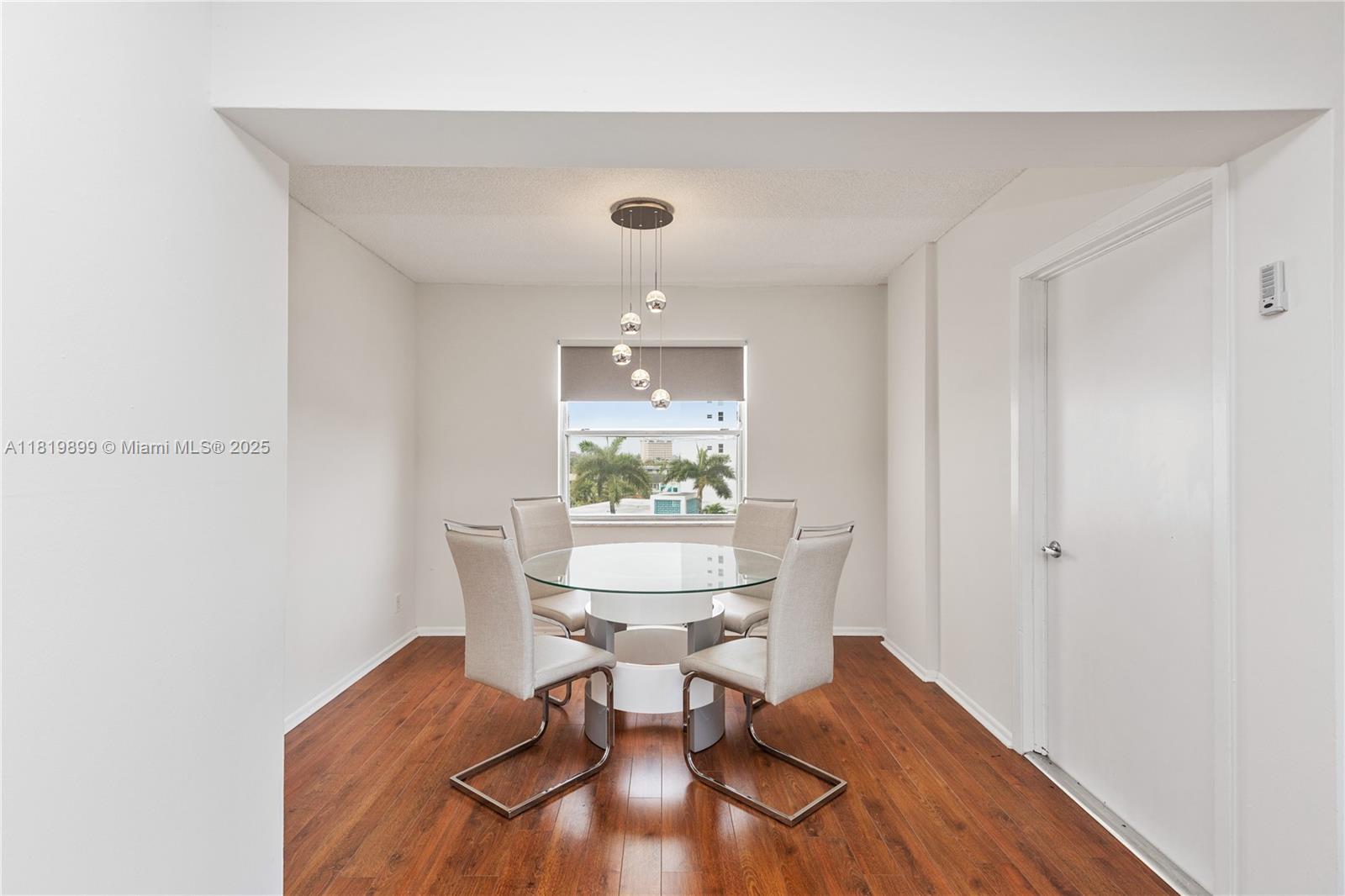 401 Golden Isles Drive, Unit 613 Hallandale Beach, FL 33009 - Photo 6 of 39 a workspace with furniture and wooden floor