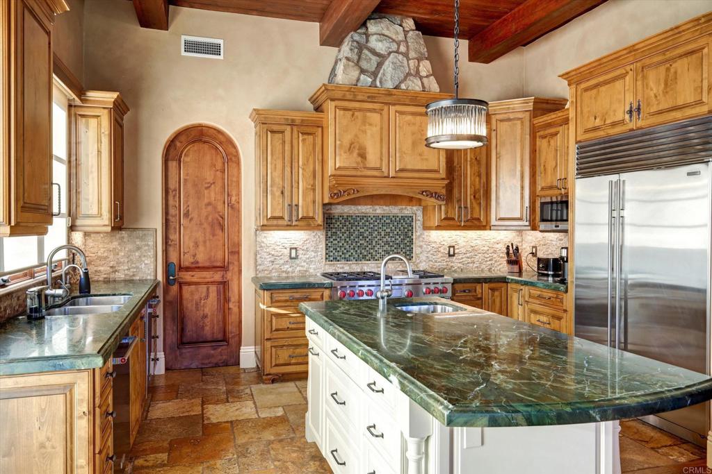 18179 El Brazo Rancho Santa Fe, CA 92067 - Photo 14 of 69 a kitchen with stainless steel appliances granite countertop a stove a sink and a refrigerator