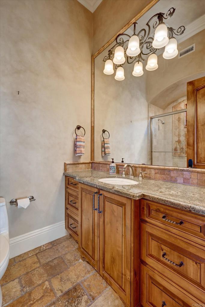 18179 El Brazo Rancho Santa Fe, CA 92067 - Photo 22 of 69 a bathroom with a granite countertop sink a large mirror and vanity