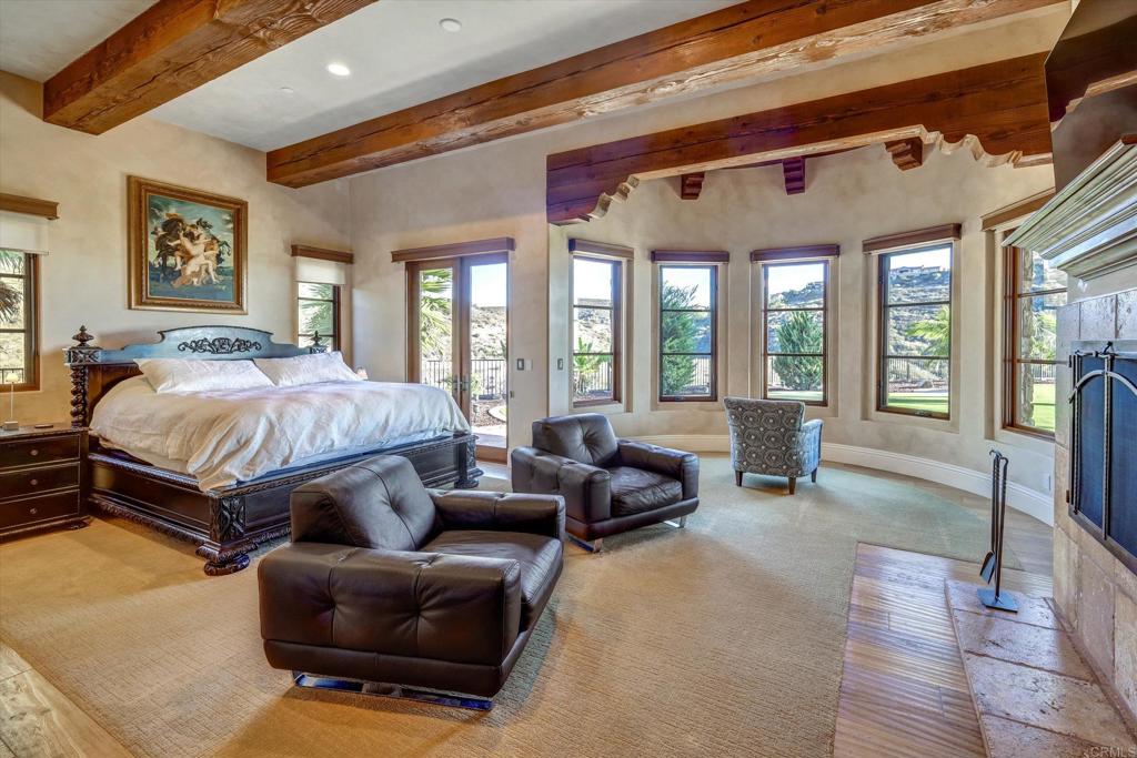 18179 El Brazo Rancho Santa Fe, CA 92067 - Photo 24 of 69 a bedroom with a bed couch and large windows