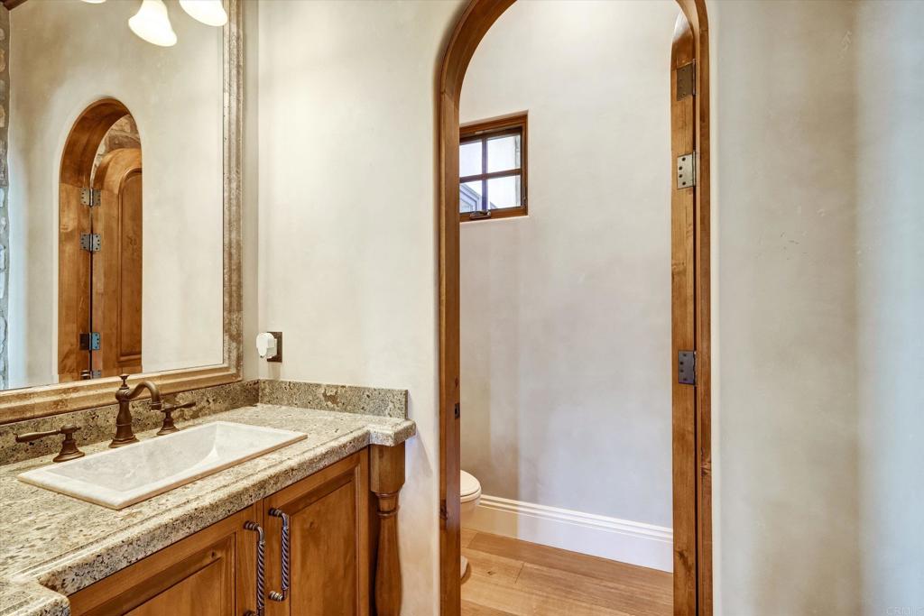 18179 El Brazo Rancho Santa Fe, CA 92067 - Photo 30 of 69 a bathroom with a granite countertop sink and a mirror