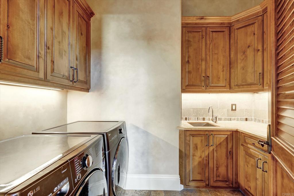 18179 El Brazo Rancho Santa Fe, CA 92067 - Photo 31 of 69 a kitchen with a sink a stove and cabinets