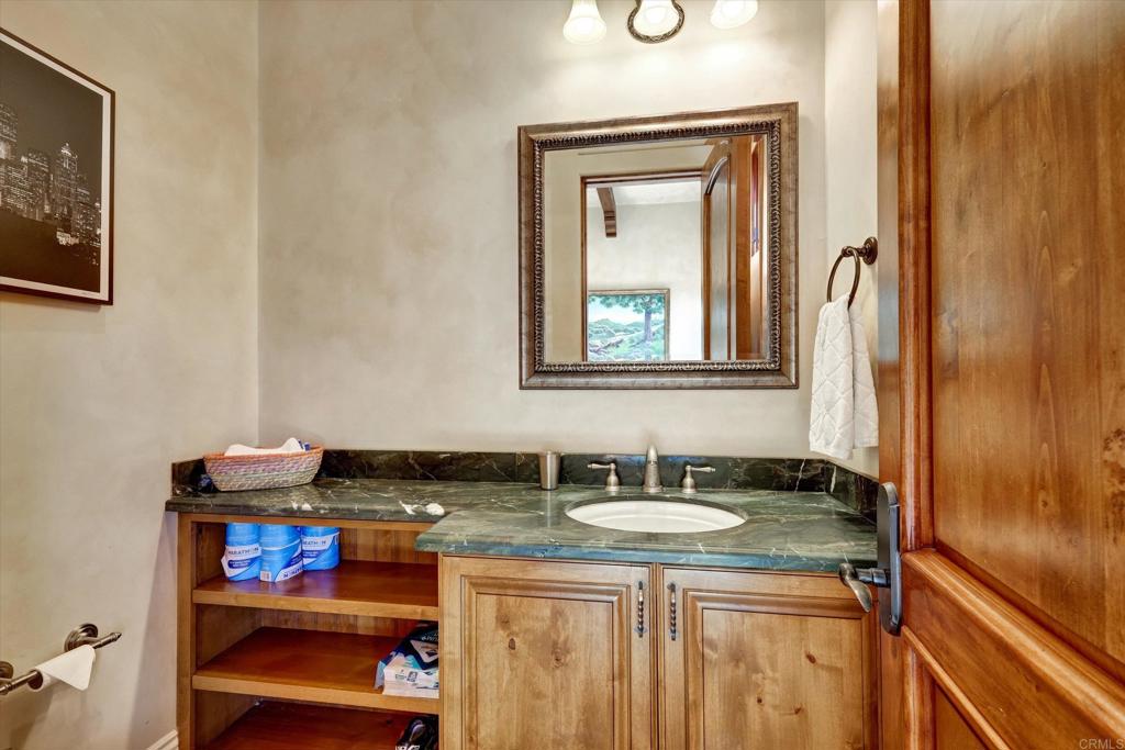 18179 El Brazo Rancho Santa Fe, CA 92067 - Photo 35 of 69 a bathroom with a granite countertop sink and a mirror