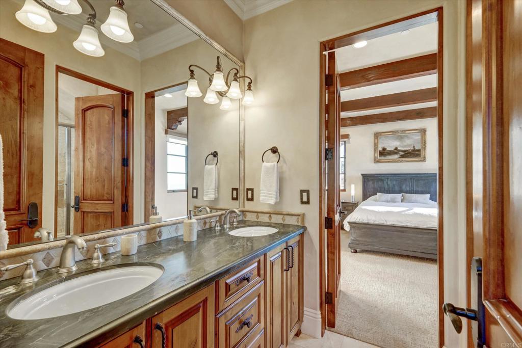 18179 El Brazo Rancho Santa Fe, CA 92067 - Photo 39 of 69 a en suite bathroom with a sink a large mirror and a shower